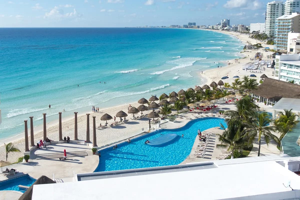 A rooftop resort pool overlooking the Cancún hotel zone coastline