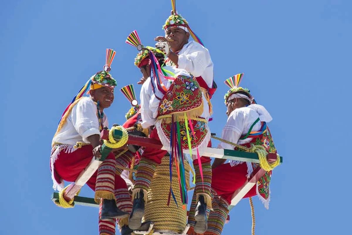 Papantla flyers in bright costumes performing the Voladores ritual